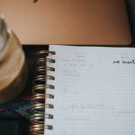 white notebook page on brown wooden table