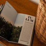 an open magazine sitting on top of a wooden table