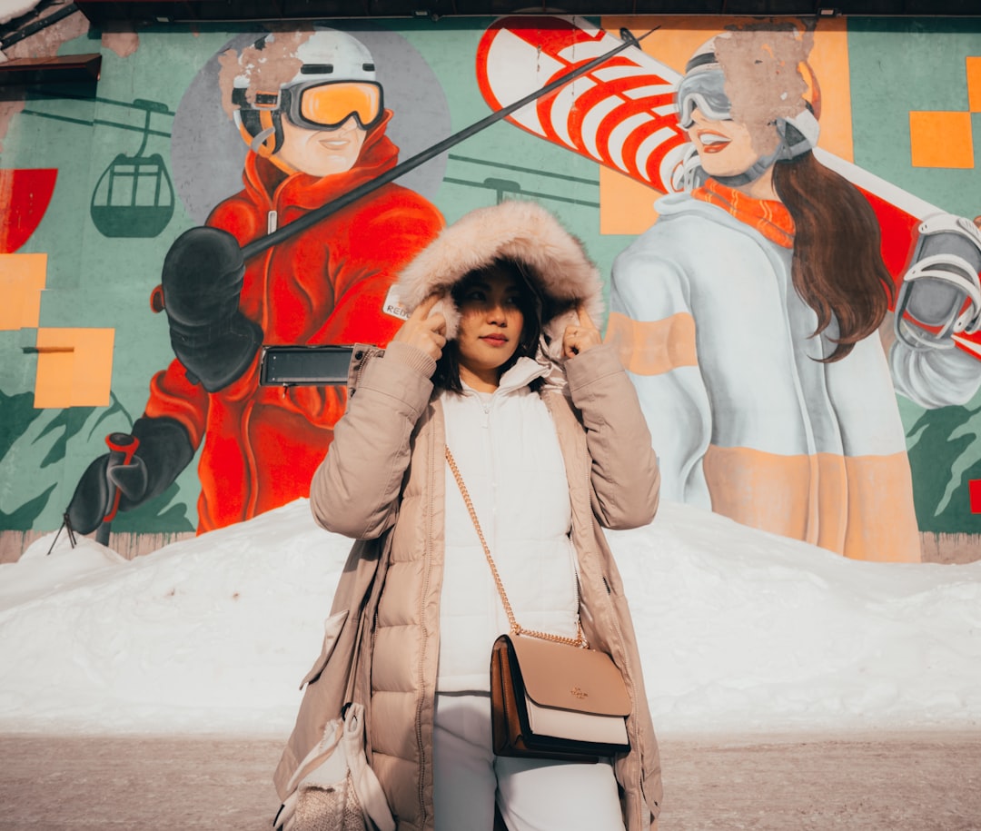 a person standing in front of a wall with art