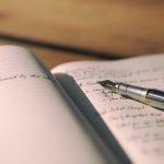 pen on white lined paper selective focus photography