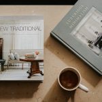 brown ceramic mug near two books
