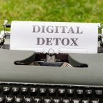 a typewriter with a paper that reads digital detox