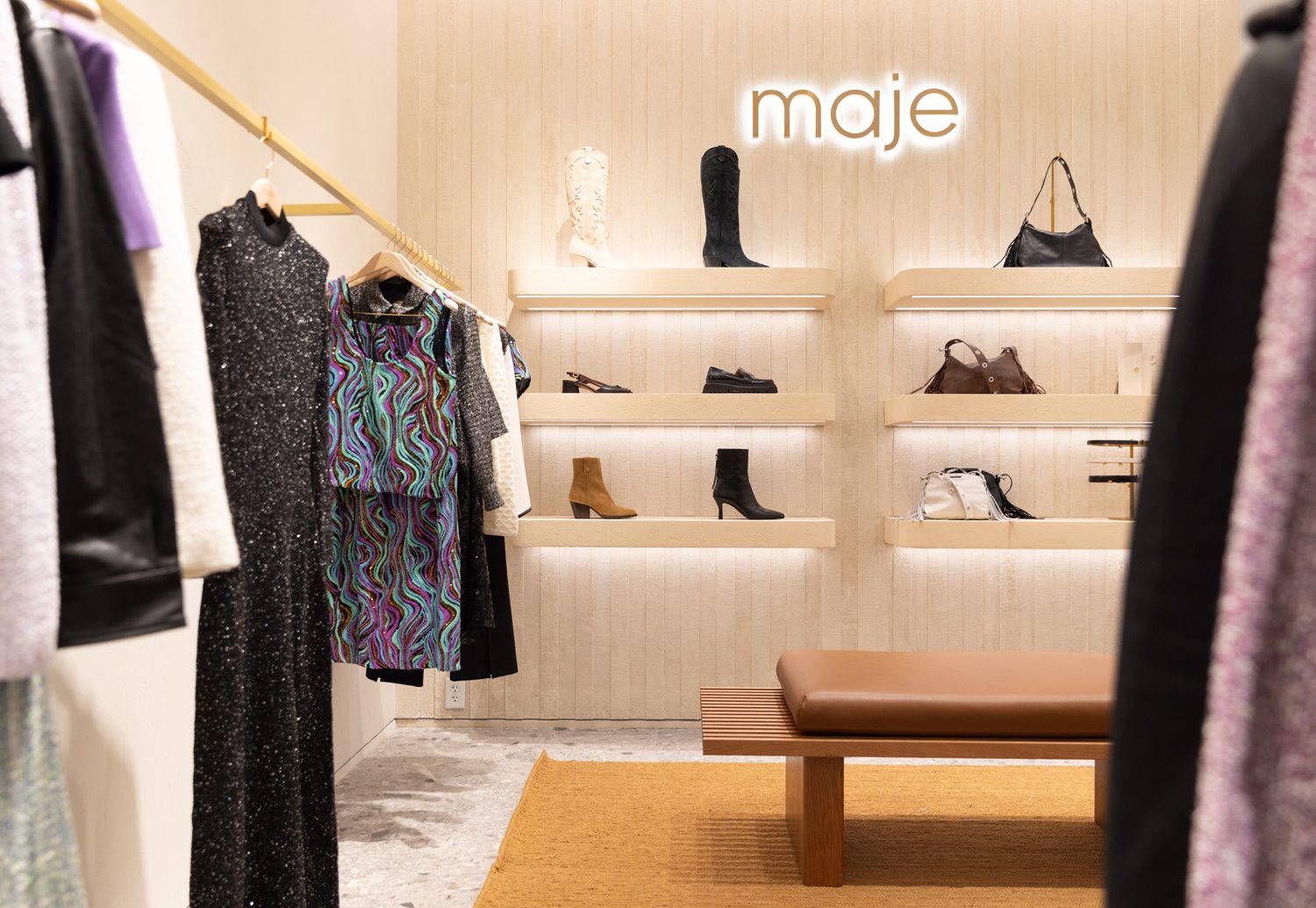 Beautifully curated dress racks and premium apparel inside Maje boutique