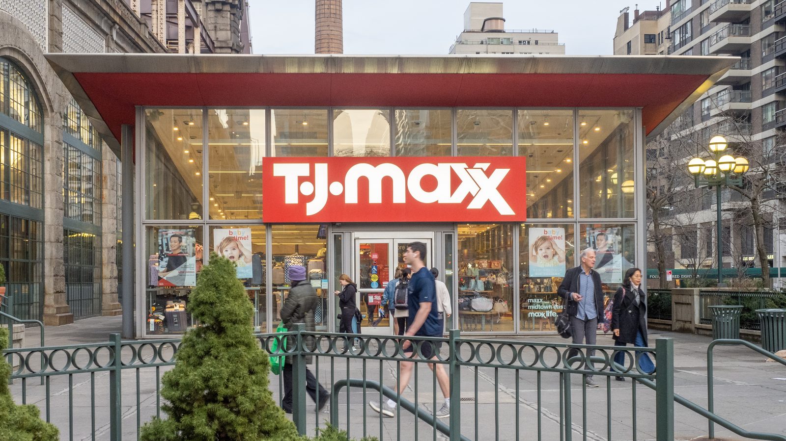 Organized hangers of colorful designer clothing inside TK Maxx store