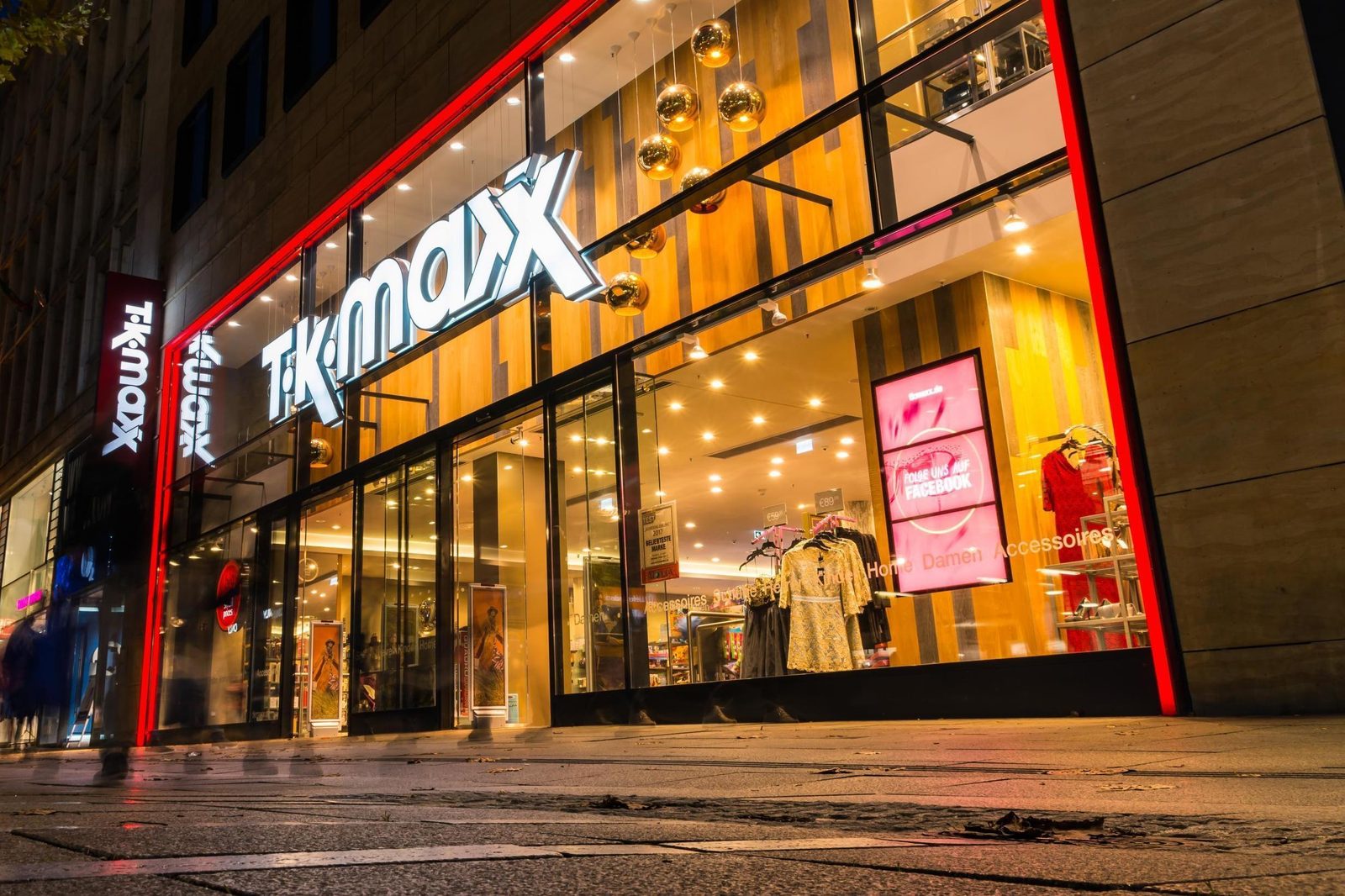 Satisfied fashion shoppers carrying TK Maxx shopping bags representing smart consumption