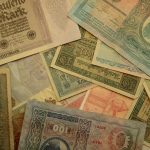 a pile of different types of currency