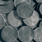 a pile of silver coins sitting on top of a table