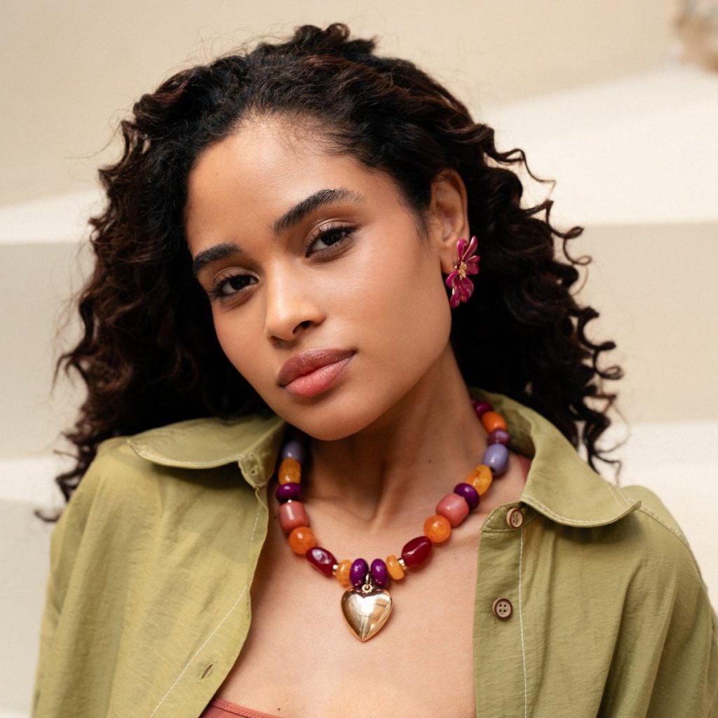 Model styling a colourful Balaboosté heart pendant necklace