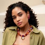 Model styling a colourful Balaboosté heart pendant necklace