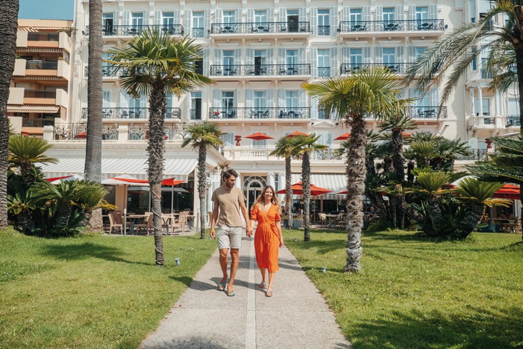A couple relaxing outside the Vacances Bleues Royal Westminster in Menton