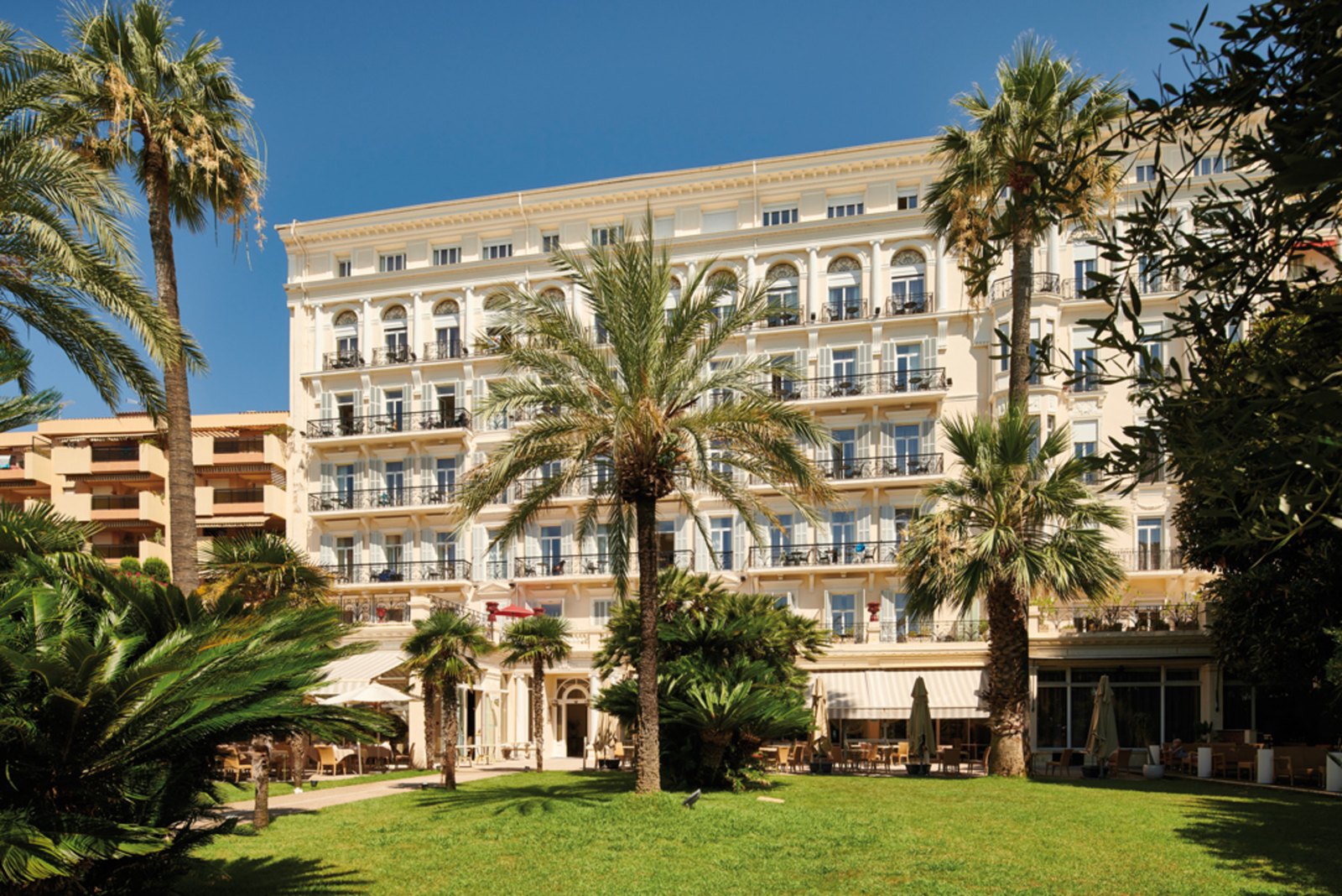 The elegant facade and garden of the Vacances Bleues Royal Westminster in Menton