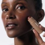 Aime skincare products arranged in a soft blush beauty editorial
