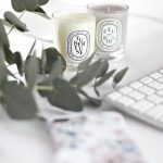 white and black ceramic mug beside white computer keyboard
